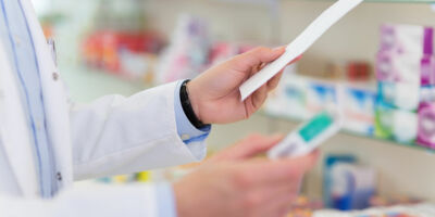 Pharmacist filling prescription in pharmacy